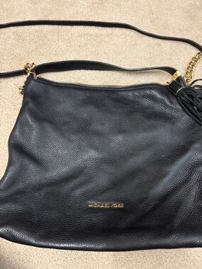 Michael Kors Black Leather Shoulder Bag with Gold Hardware and Tassel